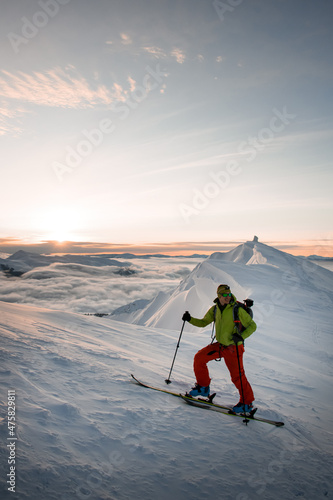 male skier against the backdrop of picturesque landscape view of sky and clouds