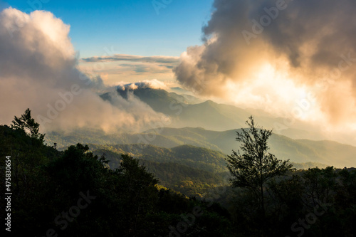 beautiful high mountain scenery covered with clouds and the evening sun