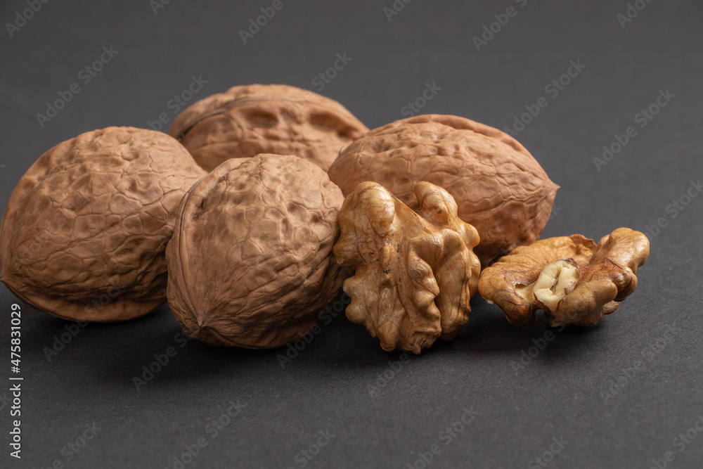 Walnuts scattered on a dark background, macro Walnuts scattered on a dark background, macro