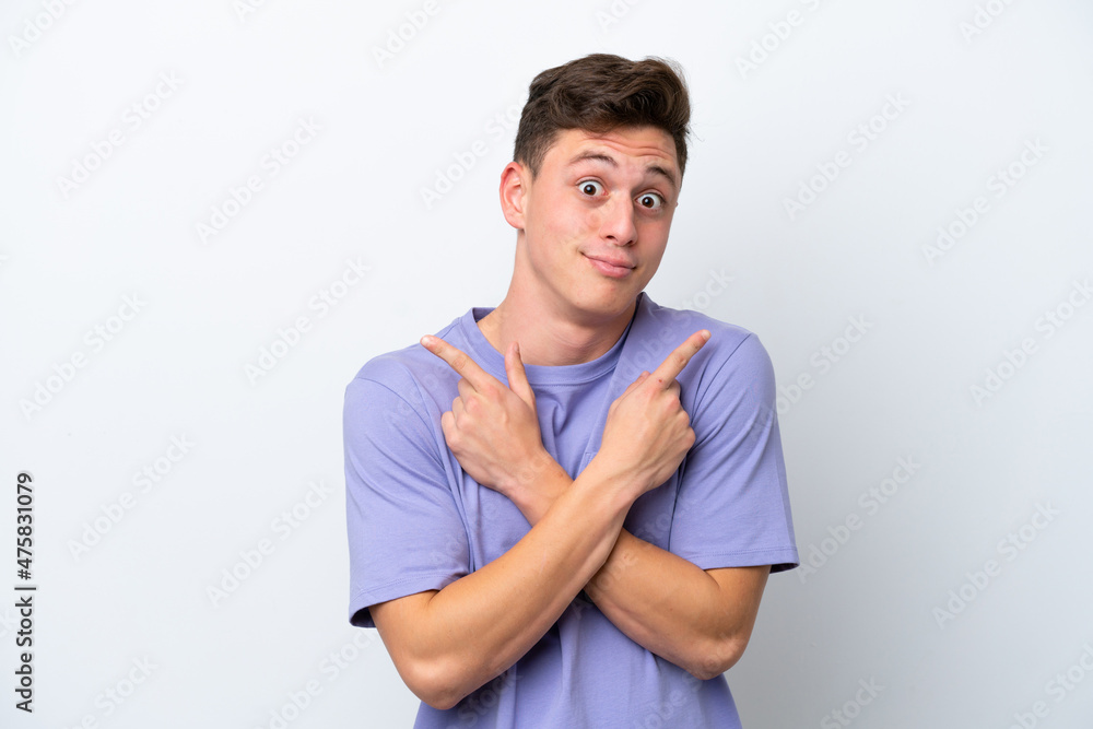 Obraz premium Young handsome Brazilian man isolated on white background pointing to the laterals having doubts