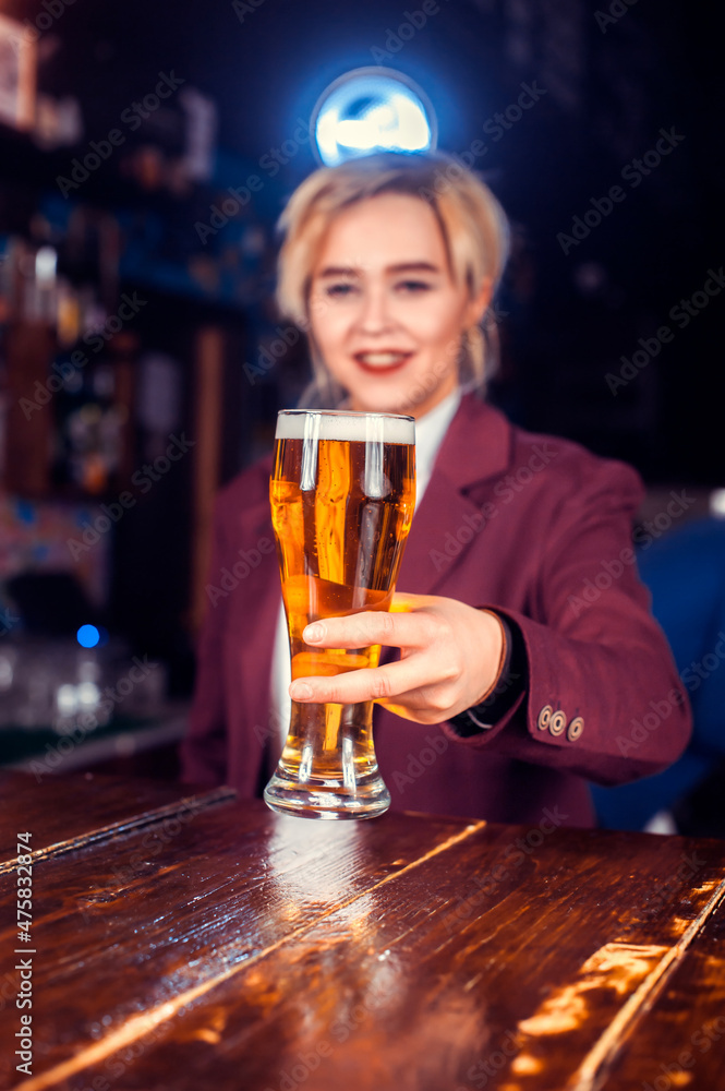 Girl barman concocts a cocktail in the saloon