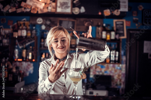 Girl bartender mixes a cocktail at the porterhouse