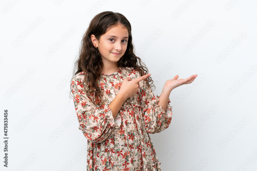 Little caucasian girl isolated on white background holding copyspace imaginary on the palm to insert an ad Little caucasian girl isolated on white background holding copyspace imaginary on the palm to insert an ad