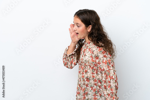 Little caucasian girl isolated on white background shouting with mouth wide open to the side