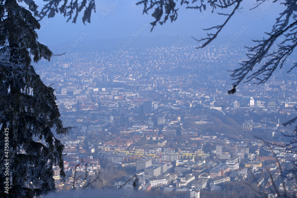 Aerial view over City of Zürich seen from local mountain Uetliberg on a foggy winter day. Photo taken December 18th, 2021, Zurich, Switzerland.