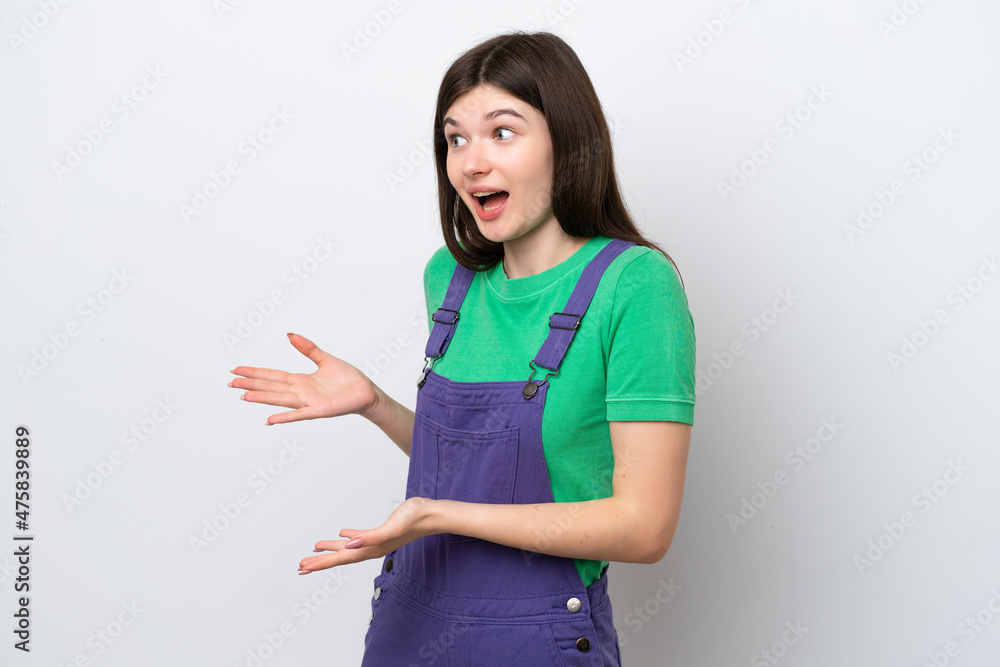 Young Russian woman isolated on blue background with surprise expression while looking side Young Russian woman isolated on blue background with surprise expression while looking side