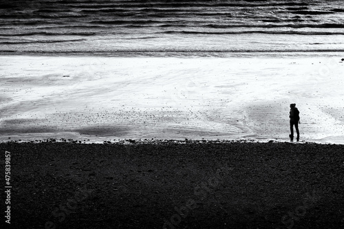 silhouette of a lady on the beach in black and white Cornwall UK 