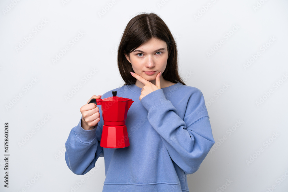 Young Russian woman holding coffee pot isolated on white background thinking Young Russian woman holding coffee pot isolated on white background thinking