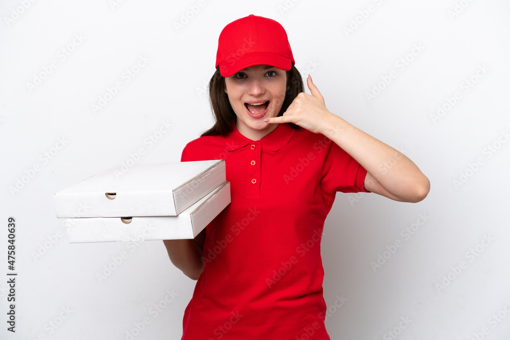 Young Russian pizza delivery picking up pizza boxes isolated on white background making phone gesture. Call me back sign Young Russian pizza delivery picking up pizza boxes isolated on white background making phone gesture. Call me back sign