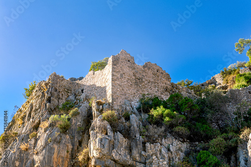 ruins of fortress walls on rocky mountain slopes near the antique city of Olympos, Turkey