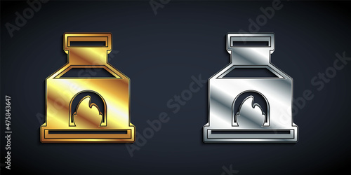 Gold and silver Blacksmith oven icon isolated on black background. Long shadow style. Vector