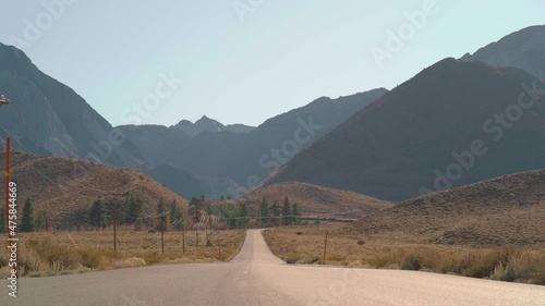 A Static 4K shot of a road in Sierra Nevada mountains in California leading to Convict lake