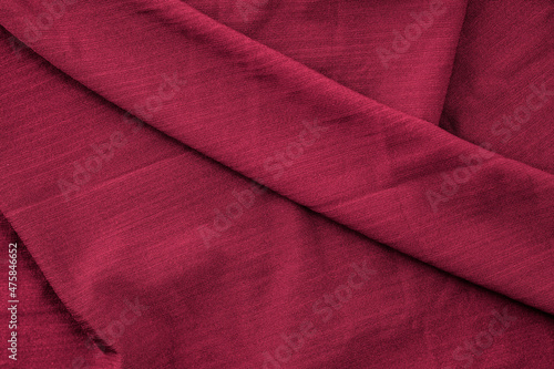 Luxurious romantic texture background of folded red color silk fabric