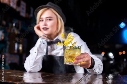 Girl bartender concocts a cocktail at the beerhouse photo