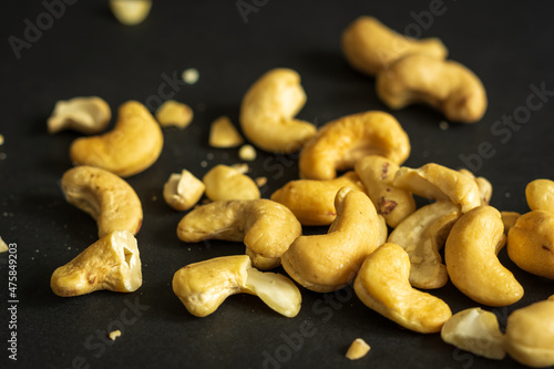 roasted cashew nuts closeup on dark background