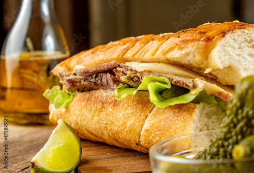 Cuban sandwich with meat and cheese, close-up, wooden table, Traditional cubano sandwich.
