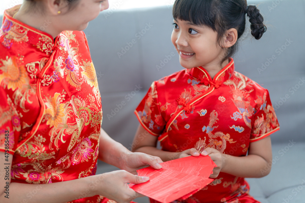 happy Asian little girl received red envelope from mother for Chinese new year happy Asian little girl received red envelope from mother for Chinese new year