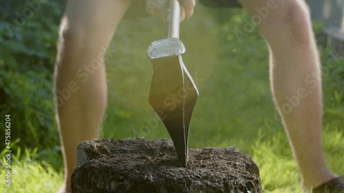 Slow motion wood chopping with an axe. Front view.