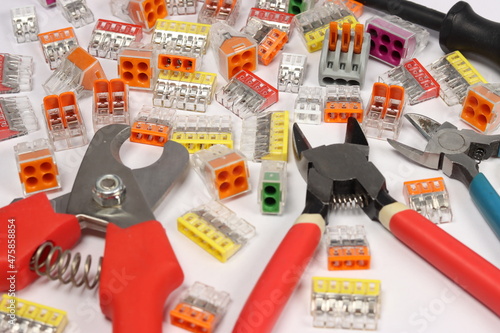 Plastic wire connectors of different colors for different connections and mounting tools.