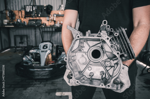 Φωτογραφία The mechanic go kart racing service pours fuel into the tank