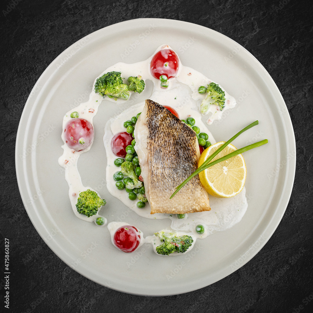 Pike perch on a vegetable pillow . Isolated on a black background. Pike perch on a vegetable pillow . Isolated on a black background.