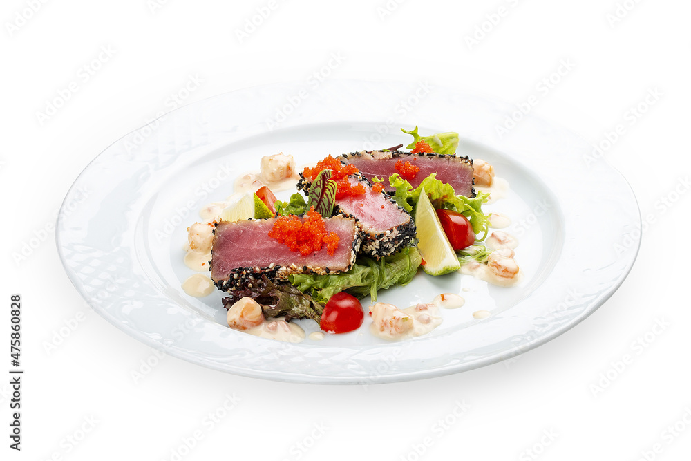 Tuna on a pillow of chuka with shrimp sauce . Isolated on a black background. Tuna on a pillow of chuka with shrimp sauce . Isolated on a black background.