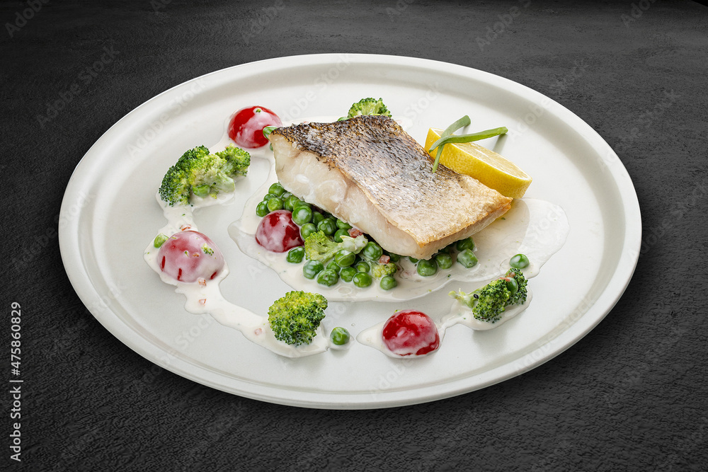 Pike perch on a vegetable pillow . Isolated on a black background. Pike perch on a vegetable pillow . Isolated on a black background.