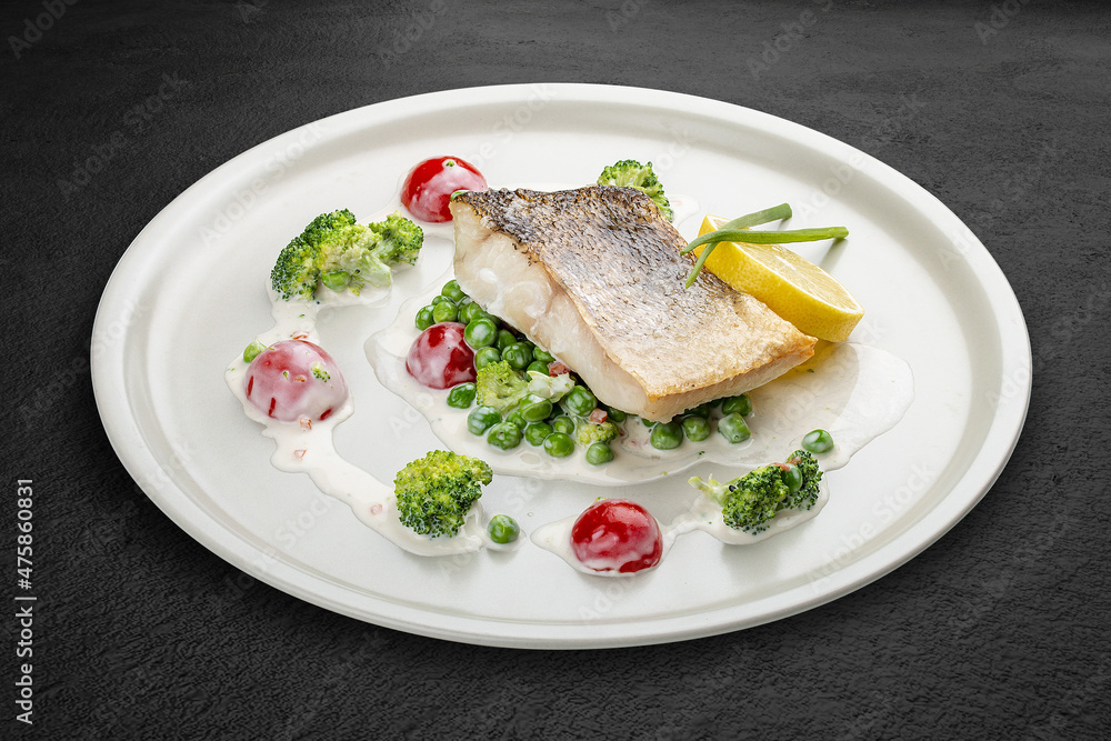 Pike perch on a vegetable pillow . Isolated on a black background. Pike perch on a vegetable pillow . Isolated on a black background.