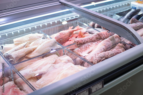 Fresh frozen fish in the refrigerator in the supermarket