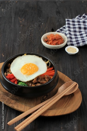 Bibimbap Rice with Mix Sautee Vegetables, Beef,  and Egg. Served with Red Spicy Bibimbap Sauce and Sesame Oil. Copy Space for Text