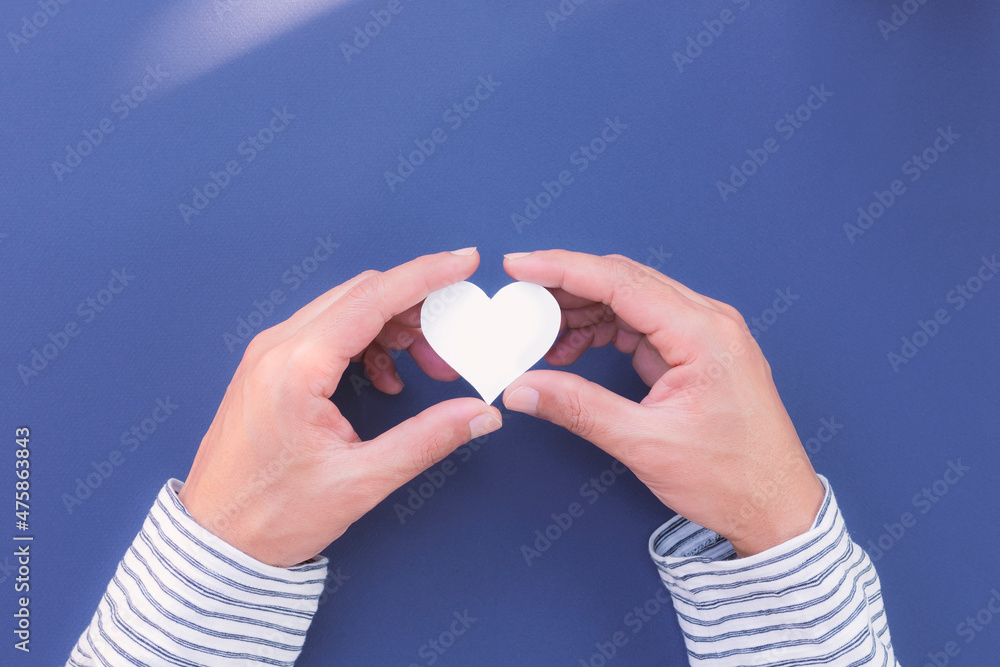 Man hands holding white heart, heart health, donation, happy volunteer charity, CSR responsibility, world health day, world mental health day, foster home, wellbeing, love, Valentine's Day. Man hands holding white heart, heart health, donation, happy volunteer charity, CSR responsibility, world health day, world mental health day, foster home, wellbeing, love, Valentine's Day.