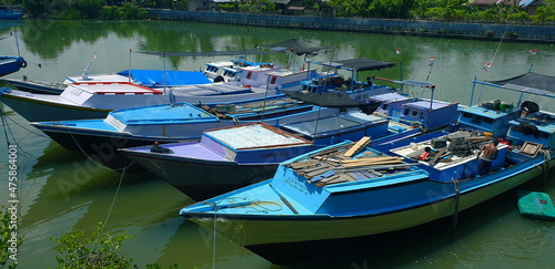 Wallpaper Mural Buton, Southeast Sulawesi, INDONESIA December 4, 2021, a row of traditional fishing boats with various colors anchored around the shoreline Torontodigital.ca