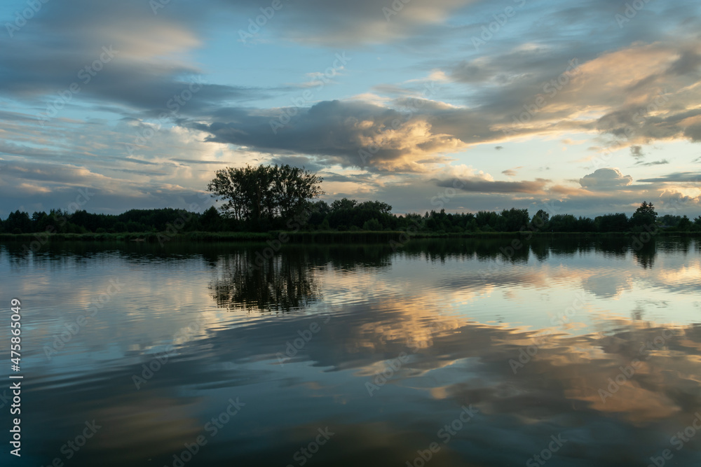 The reflection of the evening clouds in the lake water The reflection of the evening clouds in the lake water