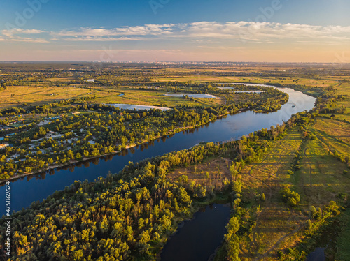 Aerial drone view. The bend of a wide river among green meadows. © Ryzhkov Oleksandr
