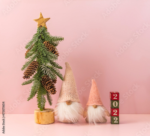 Cute Santa Claus dolls with christmas tree and 2022 year concept with blocks and text board,Happy New Year and merry Christmas