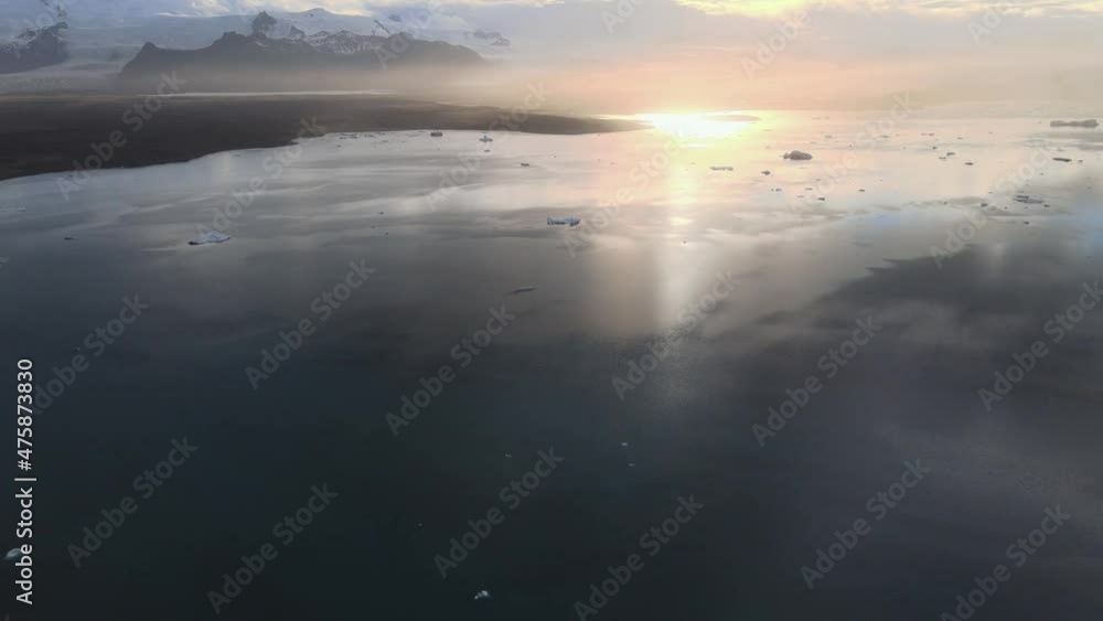 sunrise over the sea with dramatic mountains and sunset in the background - Iceland drone shot sunrise over the sea with dramatic mountains and sunset in the background - Iceland drone shot