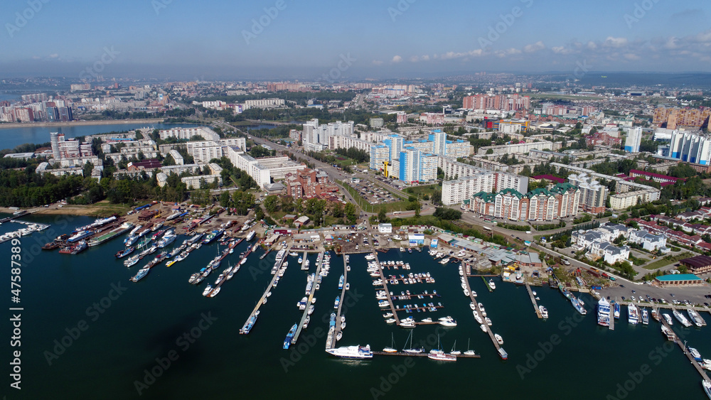 View from a height to the City of Irkutsk. Parked yachts and boats.