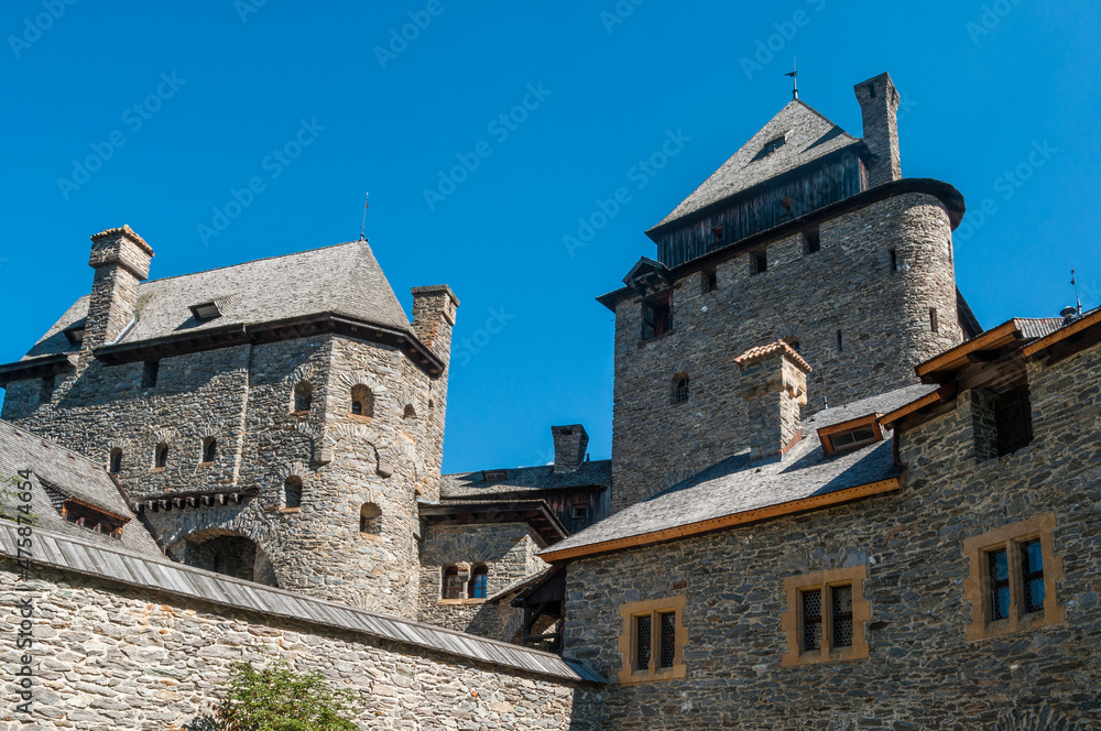 Detailaufnahme einer alten Burg mit Turm, vor strahlend blauem Himmel