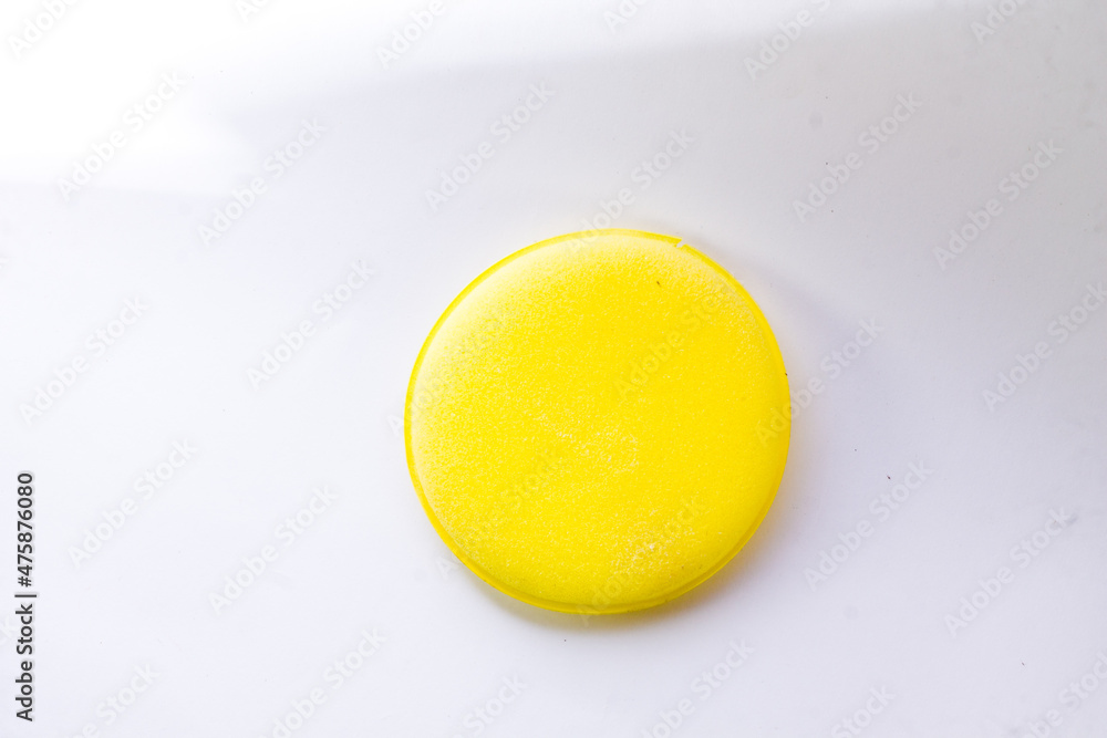 yellow dishwashing sponge on an isolated white background.