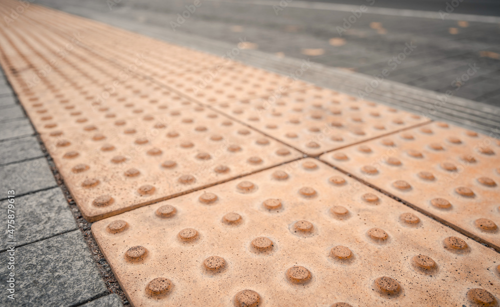Fototapeta premium Yellow Braille blocks on public transport station for person with a physical disability