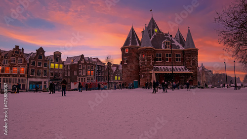 Canvas Print Snowy Nieuwmarkt with the Waag building in the city center from Amsterdam in the