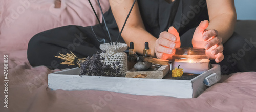 Wellness,tarot, health mental.Girl meditates yoga at home with aromatherapy palo santo Care, Wellness , meditation, spa, relax occultism, spiritual cleansing..