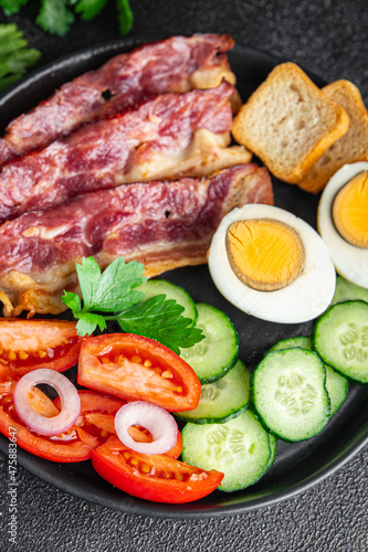 English breakfast eggs, bacon, tomato, cucumber, toast bread healthy meal diet snack on the table copy space food background rustic 