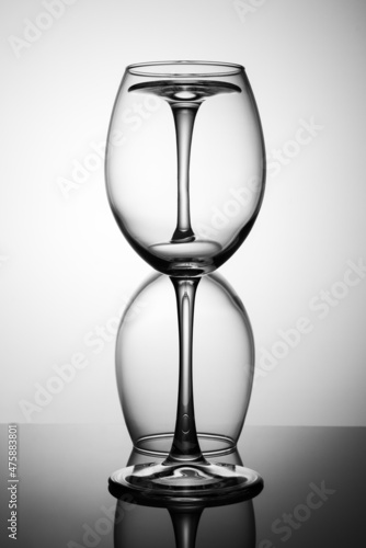 two empty glasses on a black table with a reflection
