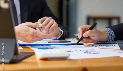 Business team present. Business man hands hold documents with financial statistic stock photo  discussion  and analysis report data the charts and graphs. Finance concept