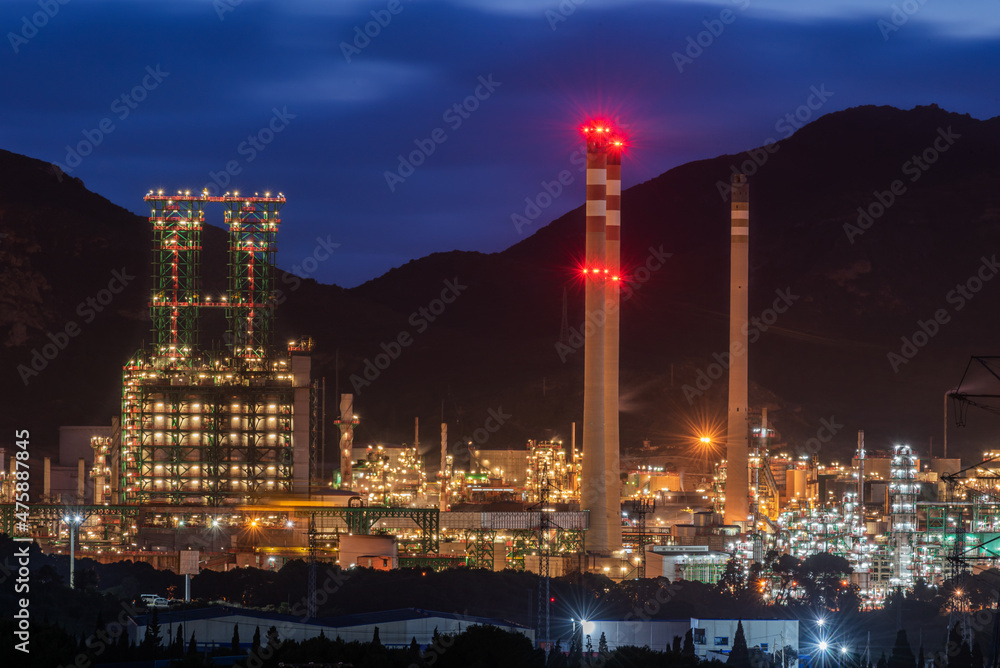 Oil refinery illuminated at night.