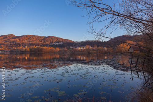 Prosecco Unesco Hills that are reflected in the waters of a lake full of water lilies at sunset. Revine Lakes, Veneto, Italy. Concept about peace and relaxation. Popular travel destination