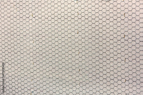 Construction mesh stretched over foam on a wall