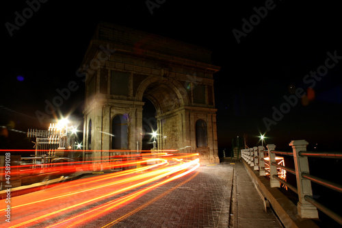 Cars driving over Arch on the dam wall at night with cars driving over in Hartbeespoort in the North West of South Africa