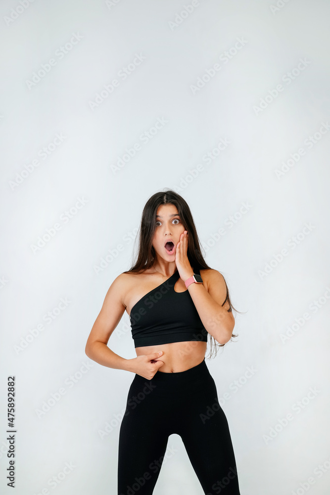 Young woman showing fat on her belly over white background. Young woman showing fat on her belly over white background.